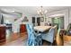 Elegant dining room features a large white table, fireplace, and access to the kitchen at 2136 N Landing Way, Marietta, GA 30066