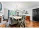 Inviting dining room with stylish chairs, bright window, a fireplace, and modern light fixture at 2136 N Landing Way, Marietta, GA 30066