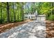 View of traditional home with two-car garage on a lot surrounded by mature trees at 2136 N Landing Way, Marietta, GA 30066