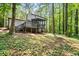 Exterior rear view of home features a screened porch and deck overlooking a private, wooded backyard at 2136 N Landing Way, Marietta, GA 30066