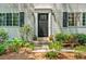 Charming front entrance with a black door, potted flowers, and manicured landscaping at 2136 N Landing Way, Marietta, GA 30066