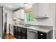 The bright kitchen features stainless steel appliances, updated counters and white cabinetry at 2136 N Landing Way, Marietta, GA 30066