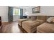 Comfortable living room showcases a large sectional sofa with wood floors and natural light from a window at 2136 N Landing Way, Marietta, GA 30066