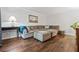 Cozy living room featuring a sectional sofa with ottoman, wood flooring, and stylish decor for relaxed living at 2136 N Landing Way, Marietta, GA 30066