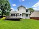 Spacious backyard featuring a large deck, lush green grass, and mature trees at 268 Heathrow Dr, Riverdale, GA 30274