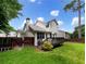 Spacious backyard featuring a wood deck, privacy fence, and lush green lawn at 268 Heathrow Dr, Riverdale, GA 30274