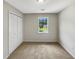 This is a neutral bedroom with a window and a closet at 268 Heathrow Dr, Riverdale, GA 30274