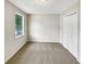 Neutral bedroom featuring carpet, a double closet and a sunny window at 268 Heathrow Dr, Riverdale, GA 30274