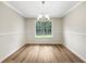 This is a dining room with a window and wood-look flooring at 268 Heathrow Dr, Riverdale, GA 30274
