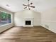 This is a large living room with a fireplace, vaulted ceilings, and wood-look floors at 268 Heathrow Dr, Riverdale, GA 30274