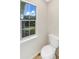 Compact half bath with a toilet and window for natural lighting at 268 Heathrow Dr, Riverdale, GA 30274