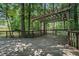 Spacious back deck surrounded by nature's beauty featuring a pergola and mature trees at 2695 Moon Cabin Dr, Powder Springs, GA 30127