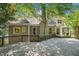 Exterior view of the backyard featuring a spacious deck, lush greenery, and a cozy pergola at 2695 Moon Cabin Dr, Powder Springs, GA 30127