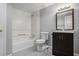 Bathroom featuring a shower-tub combo, vanity with sink, toilet, and gray tile floors at 2695 Moon Cabin Dr, Powder Springs, GA 30127