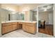 Bright bathroom with double vanity, tile floors, and a doorway leading to an adjacent bedroom at 2695 Moon Cabin Dr, Powder Springs, GA 30127