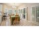 Bright dining area features tile floors, a chandelier, and windows with white shutters and bench seating at 2695 Moon Cabin Dr, Powder Springs, GA 30127