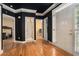 Elegant entryway boasting wood floors, contrasting trim, and three interior door ways at 2695 Moon Cabin Dr, Powder Springs, GA 30127