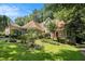 View of a charming single Gathering home with lush landscaping and mature trees at 2695 Moon Cabin Dr, Powder Springs, GA 30127