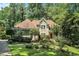 Charming single Gathering home featuring mature trees and lush landscaping at 2695 Moon Cabin Dr, Powder Springs, GA 30127