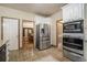 Kitchen featuring stainless-steel appliances and access to dining and living spaces at 2695 Moon Cabin Dr, Powder Springs, GA 30127