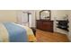 View of the bedroom showing the hardwood floors and a large dresser with a mirror at 2695 Moon Cabin Dr, Powder Springs, GA 30127