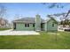 View of the house with a green lawn and a patio in the backyard at 2082 Blackberry Ln, Auburn, GA 30011