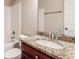 Bathroom featuring granite countertops, a tub with white subway tile, and a cherry wood vanity at 2082 Blackberry Ln, Auburn, GA 30011