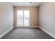 This bedroom features a large window with blinds, gray carpet and neutral paint at 2082 Blackberry Ln, Auburn, GA 30011