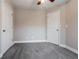 This bedroom features neutral paint, carpet floors, a ceiling fan and white baseboards and trim at 2082 Blackberry Ln, Auburn, GA 30011