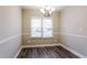 Bright dining room with hardwood flooring, chandelier lighting, and a window with backyard views at 2082 Blackberry Ln, Auburn, GA 30011