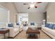Bright, staged living room with white sofas and blue accent pillows with dining area in the background at 2082 Blackberry Ln, Auburn, GA 30011