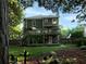 This backyard offers a multi-level deck, lush lawn, and wooded surroundings for serene outdoor living at 4601 Gann Sw Xing, Smyrna, GA 30082