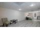 Finished basement with light wood flooring, with a comfortable seating and a small table at 4601 Gann Sw Xing, Smyrna, GA 30082
