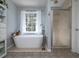 Stylish bathroom features modern tub with deck-mounted faucet and separate glass-enclosed shower at 4601 Gann Sw Xing, Smyrna, GA 30082