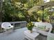 Inviting deck with white wicker furniture, ideal for enjoying the tranquil backyard setting at 4601 Gann Sw Xing, Smyrna, GA 30082