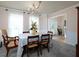 Formal dining room with a chandelier, large windows, and views into the entryway at 4601 Gann Sw Xing, Smyrna, GA 30082