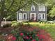 Beautiful two-story home with a well-manicured lawn and vibrant roses in the landscaped flowerbeds at 4601 Gann Sw Xing, Smyrna, GA 30082
