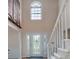 Bright two-story foyer featuring a decorative glass door and a staircase with white railing at 4601 Gann Sw Xing, Smyrna, GA 30082
