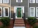 Inviting front entrance featuring a green door, brick steps, and well-maintained landscaping at 4601 Gann Sw Xing, Smyrna, GA 30082