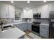 Well-lit kitchen features stainless steel appliances, gray subway tile backsplash, and plenty of cabinet space at 4601 Gann Sw Xing, Smyrna, GA 30082