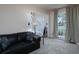Comfortable living room with large windows, plush carpeting, and a view into the entryway at 4601 Gann Sw Xing, Smyrna, GA 30082