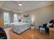 Spacious main bedroom with tray ceiling, hardwood floors, two beds, and large windows at 4601 Gann Sw Xing, Smyrna, GA 30082