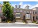 Exterior view of townhome with brick facade, attached garages, and landscaped front yards at 538 Sarabrook Pl, Sandy Springs, GA 30342