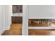 Hallway featuring hardwood floors, white trim, and access to a butler's pantry/bar at 538 Sarabrook Pl, Sandy Springs, GA 30342