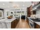 Spacious kitchen featuring hardwood floors, an island, stainless steel appliances and an open layout at 538 Sarabrook Pl, Sandy Springs, GA 30342