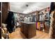 Bright walk-in closet with hardwood floors, custom shelving, hanging clothes, a center island and a crystal chandelier at 538 Sarabrook Pl, Sandy Springs, GA 30342