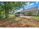 Backyard featuring a patio, a screened in porch, a grassy area, and mature trees at 70 Prince Edward Way, Covington, GA 30016