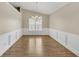 Dining room featuring chair-rail detail, hardwood floors, and a modern chandelier at 70 Prince Edward Way, Covington, GA 30016