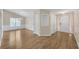 Bright foyer and dining room featuring hardwood floors, white trim, and a modern chandelier at 70 Prince Edward Way, Covington, GA 30016