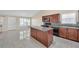 Bright kitchen featuring an island, tile floors, and modern appliances at 70 Prince Edward Way, Covington, GA 30016